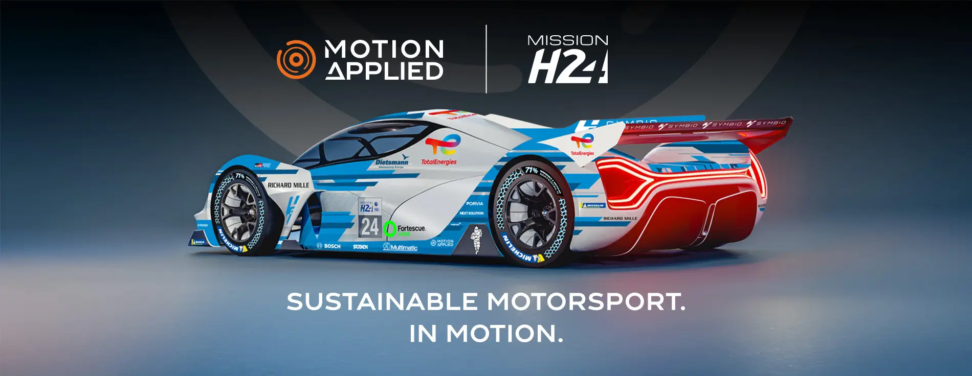 A sleek blue and white hydrogen-powered race car with aerodynamic design and sponsor logos is shown from the side on a glossy surface. Above the car are the logos “Motion Applied” and “Mission H24,” and below it the text reads “Sustainable Motorsport. In Motion.”